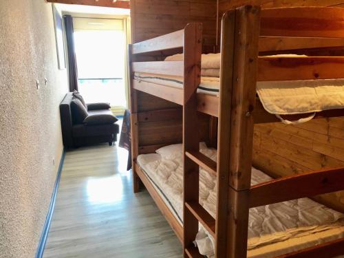 a couple of bunk beds in a room at Résidence Les Glovettes - Studio pour 4 Personnes 134 in Villard-de-Lans