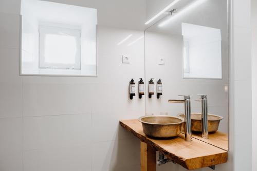 a bathroom with a bowl sink on a wooden counter at Quinta do Louredo - Évora in Évora