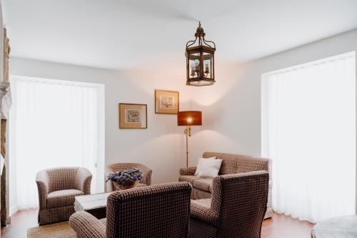 a living room with two chairs and a table at Quinta do Louredo - Évora in Évora