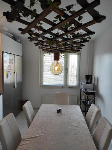 a dining room with a table and white chairs at Privat apartment Bojan in Malmö