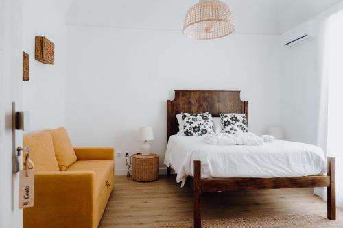 a bedroom with a bed and a couch at Quinta do Louredo - Évora in Évora
