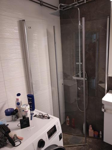 a bathroom with a shower and a microwave at Privat apartment Bojan in Malmö