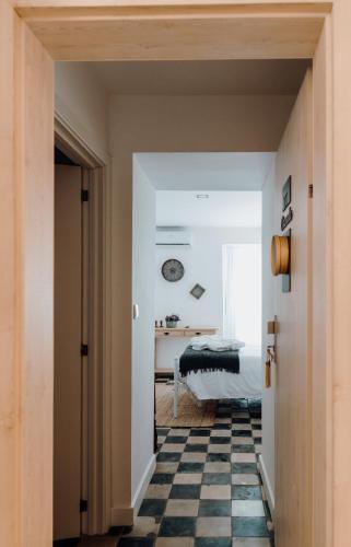 a bedroom with a black and white checkered floor at Quinta do Louredo - Évora in Évora