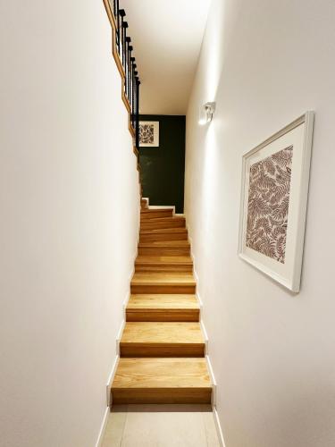 a staircase in a house with a picture on the wall at Stil Old Town Boutique Hotel in Bucharest