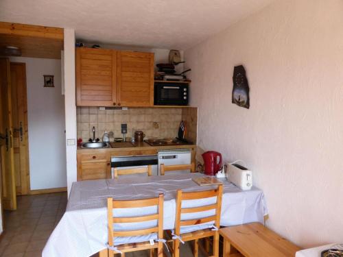 une cuisine avec une table et des chaises dans une pièce dans l'établissement Résidence Les Loges - Loges 11 MAE-4364, à Saint-Gervais-les-Bains