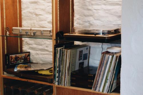 a book shelf filled with records and other items at Ranscombe House in Brixham