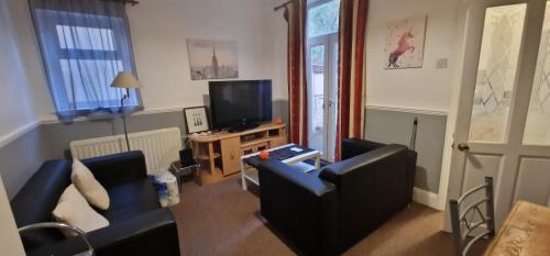 a living room with two couches and a television at Springvale house in Walkly