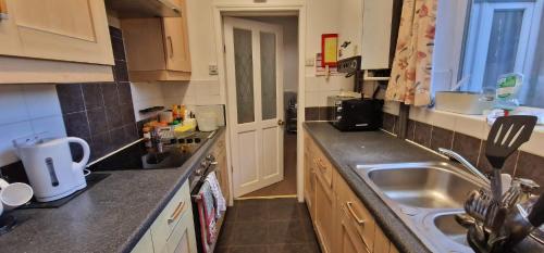 a small kitchen with a sink and a counter at Springvale house in Walkly