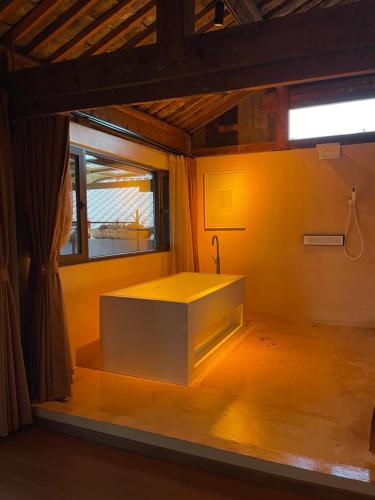 a bathroom with a sink in a room with a window at Qushe Snowy Mountain View Art B&B in Lijiang