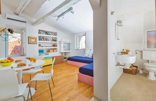 a small room with a bed and a table and chairs at Arty Apartments in the Heart of Dubrovnik by Irundo in Dubrovnik