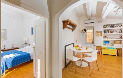 a bedroom with a bed and a table and chairs at Arty Apartments in the Heart of Dubrovnik by Irundo in Dubrovnik