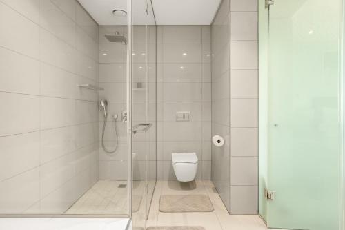 a bathroom with a toilet and a glass shower at Park Central Loft Apartment in Rosebank in Johannesburg