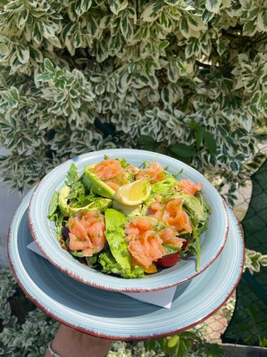 a bowl of salad with shrimp and lettuce on a plate at Hotel Pod Zámkem in Vranov nad Dyjí