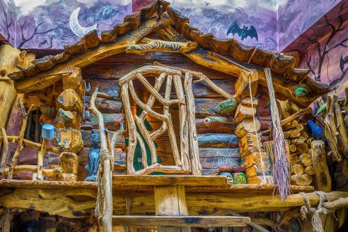 a painting of a log cabin with a house at Hotel Kocourkov in Hlinsko