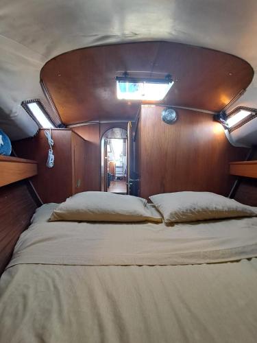 a large bed in the back of a boat at Bed & Boat L' Isola che non c'è in Viareggio