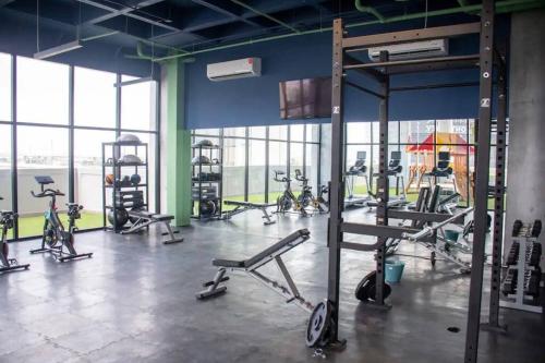 a gym with several exercise bikes in a room with windows at Departamento Arena Vive in Monterrey