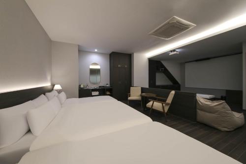 Ein Bett oder Betten in einem Zimmer der Unterkunft H Avenue Hotel Sangmu Branch