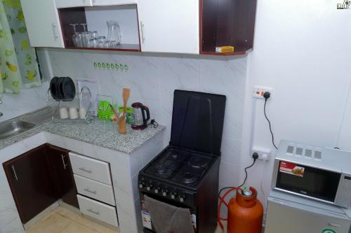 a small kitchen with a stove and a counter at Saas Homestay in Eldoret
