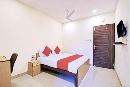 a bedroom with a bed and a tv in it at Hotel Elite Inn Ultadanga Inn Kolkata in Kolkata