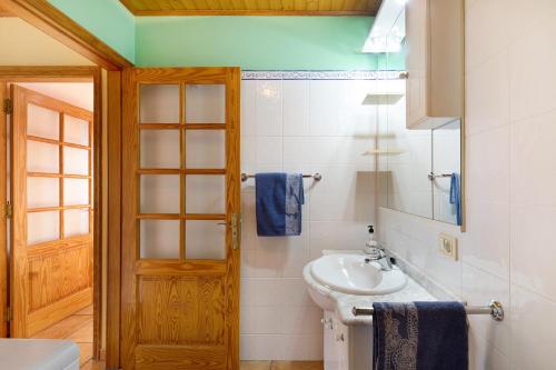 a bathroom with a sink and a toilet and a mirror at El Rincón in Tijarafe