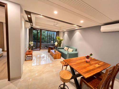 a living room with a table and a couch at Hotel South Ex Residency - South Ex near AIIMS Delhi - Couple Friendly in New Delhi