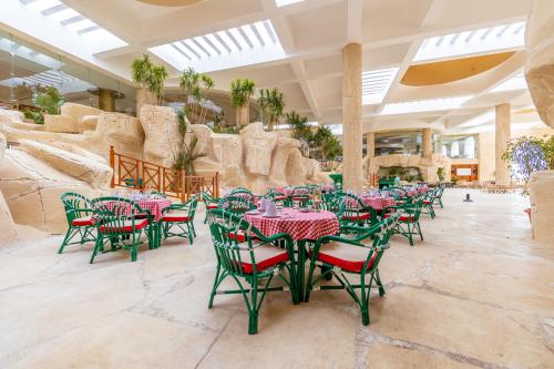 a dining room with tables and chairs in a resort at Siva Golden Bay Makadi in Hurghada