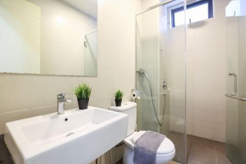 a bathroom with a sink and a toilet and a shower at Atlantis Residence - Modern Luxury in Melaka