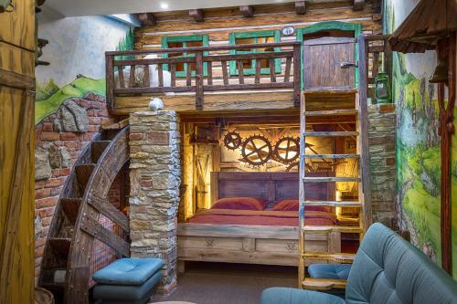 a room with a bunk bed and a ladder at Hotel Kocourkov in Hlinsko