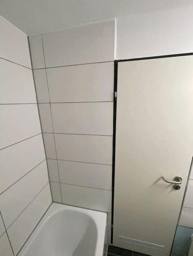 a bathroom with a toilet and a glass door at 1-Raum-Apartment Nähe Hochschule Niederrhein in Mönchengladbach