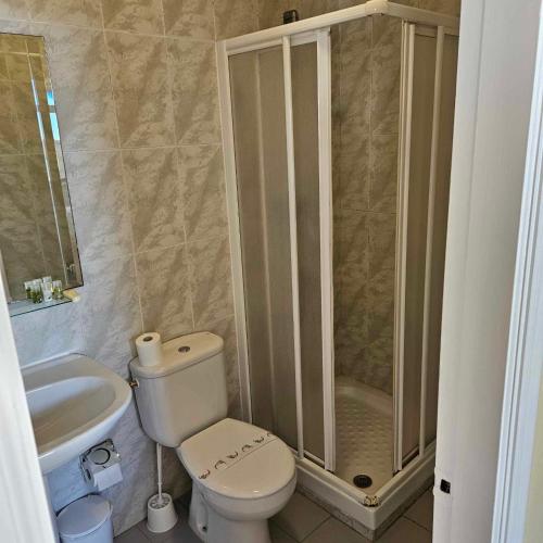 a bathroom with a shower and a toilet and a sink at Marazul By Fitzgeralds in Nerja