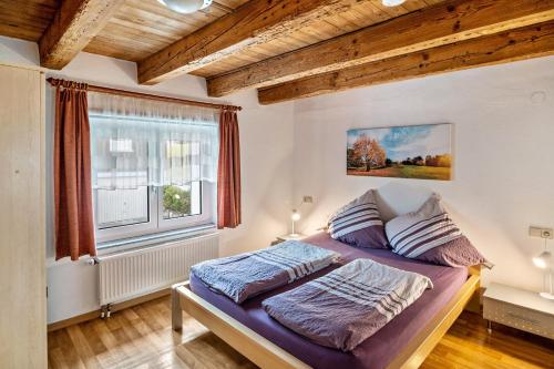 een slaapkamer met 2 bedden en een raam bij Ferienhaus Felicia OG in Ravensburg