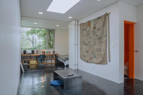 a living room with a table in the middle of a room at Motif No.1 Guest House in Paju