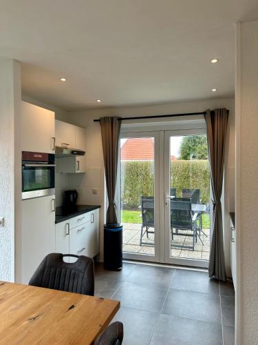 a kitchen with a table and a dining room at Chateau Noordwijk in Noordwijk