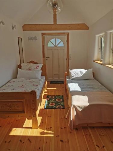 a room with two beds in front of a door at Ferienwohnung in Anni's Ferienhaus 