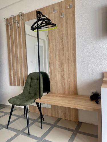 a green chair sitting next to a mirror at Villa Radozda in Struga