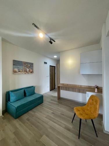 a living room with a green couch and a chair at Villa Radozda in Struga