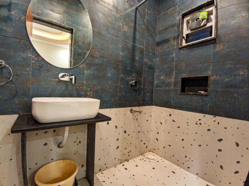 a bathroom with a sink and a mirror at The Royal Rivera Resort in Bhuj