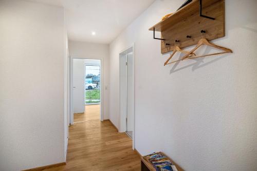 a hallway of a home with white walls and wooden floors at Kiefer in Ravensburg