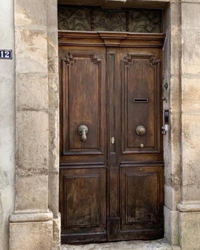 a large wooden door in a stone building at Le Couvent des Ecrevisses in Barjols