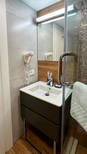 a bathroom with a sink and a mirror at Silver 39 Corner Hotel in Tbilisi City