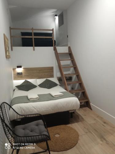 a bedroom with a bunk bed and a staircase at Balhondo Open Village in Puebla de Alcocer