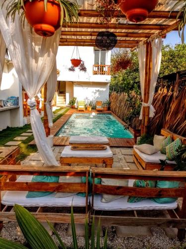 a swimming pool in the middle of a yard at Wander Boutique Hotel in El Paredón Buena Vista