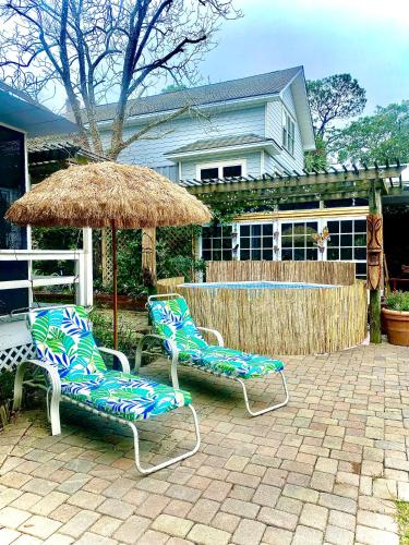 two chairs and an umbrella on a patio at Creekside Paradise in Tybee Island