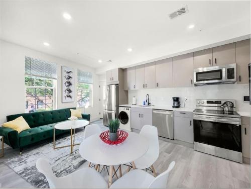 a kitchen and living room with a table and chairs at Classy Capitol Hill APT, Steps from DC Attraction in Washington, D.C.