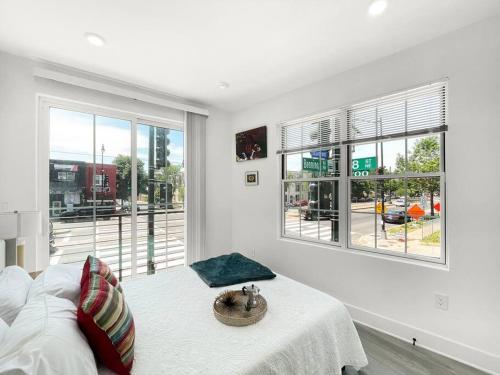 a white room with a bed and a window at Classy Capitol Hill APT, Steps from DC Attraction in Washington, D.C.