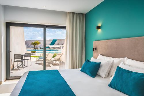 a hotel room with a bed and a view of a patio at Occidental Mar Menor in Cartagena