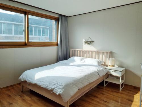 a bedroom with a large bed and a window at [My Place] max8ppl/3rooms/3Qbeds/Migeum stn/SNUBH in Seongnam