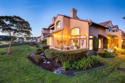 a large house with a yard with grass at 'Sunsets Over Catalina' - An Insider's Secret Hideaway with an Ocean View! in Dana Point