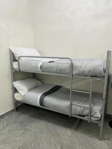 a couple of bunk beds in a room at House Napoli Capodichino in Naples