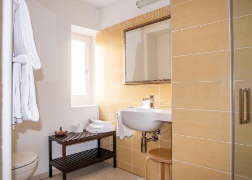 La salle de bains est pourvue d'un lavabo et de toilettes. dans l'établissement Guesthouse Arosio B&B, à Arosio